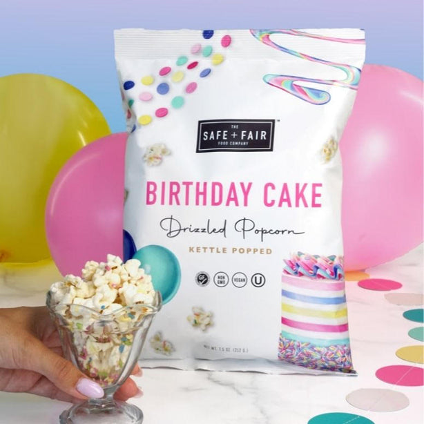 birthday cake drizzled popcorn bag on table setting